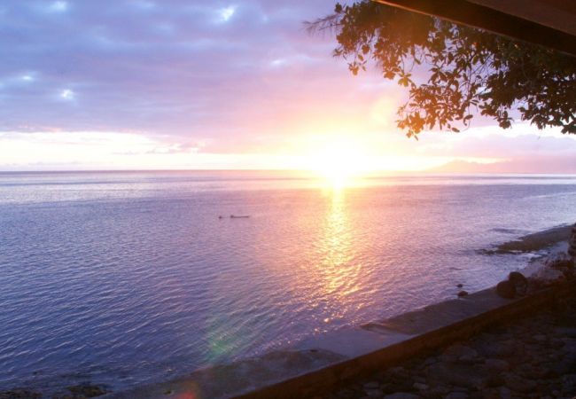 Sunset on the lagoon from the terrace of the Villa Vahineria Dream, vacation rentals feet in the water in Tahiti