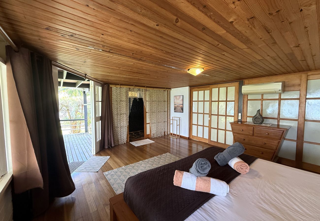 Spacious air-conditioned bedroom with en-suite bathroom, private terrace and tropical garden view