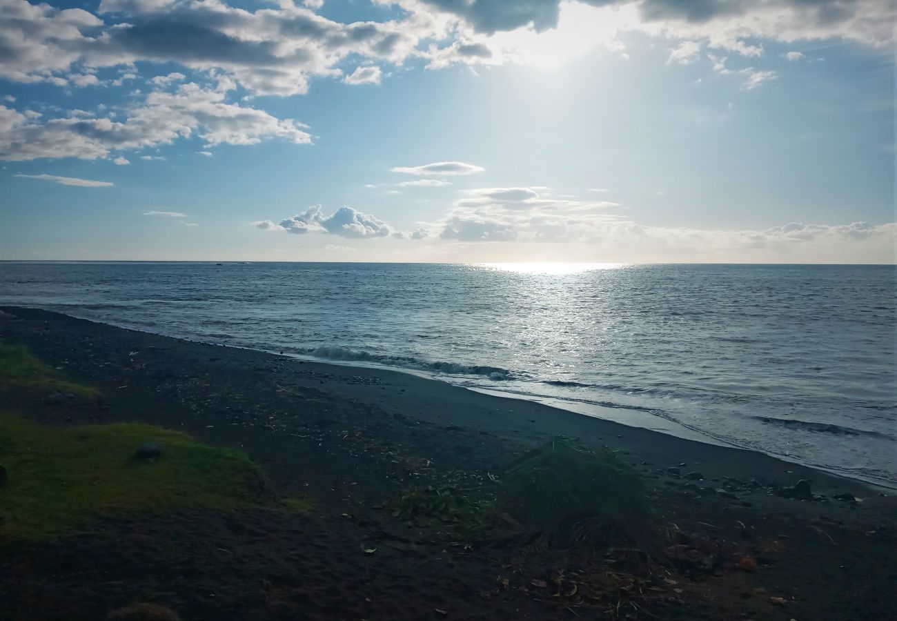 Free-access black sand beach with views over Moorea